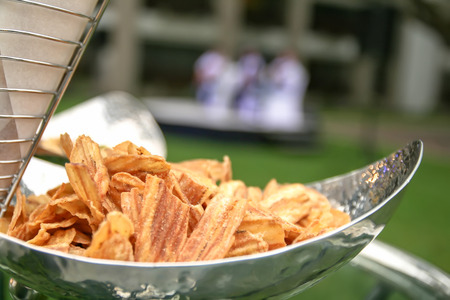 Sweet Banana crisps as a snack are served in stainless steel plate into the party.の写真素材