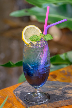 Blue Hawaii mix soda in cocktail glass set on the table ready to serve.の写真素材