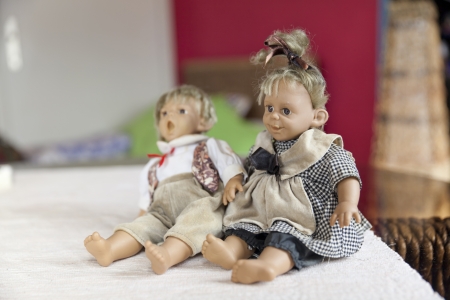 funny dolls girl and boy on bedの写真素材