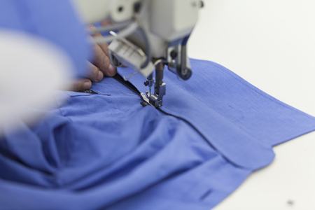 sewing machine working part with blue clothの写真素材