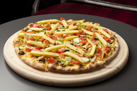 vegetarian pizza with cucumber, tomato and French friesの写真素材