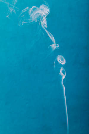 smoke on blue wall close upの写真素材