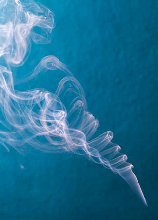 smoke on blue wall close upの写真素材