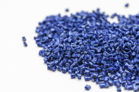 plastic granules, blue and gold close up