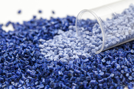 plastic granules, blue and gold close up