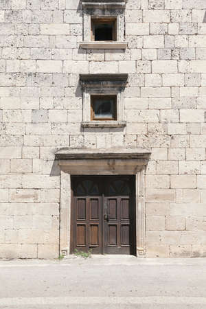 old door on old rock houseの写真素材