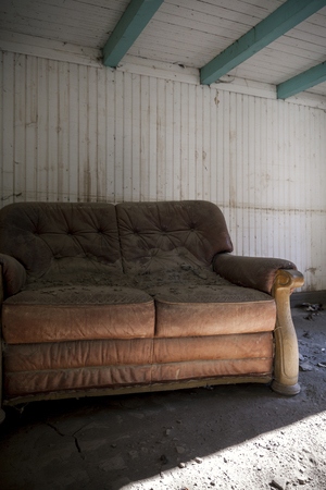 old leather sofa in an abandoned houseの写真素材