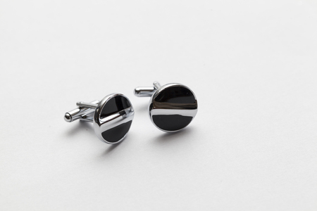 silver cufflinks on white background, close up
