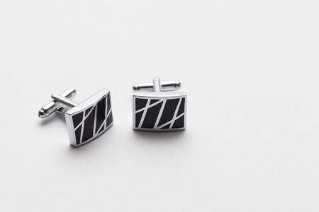 silver cufflinks on white background, close up