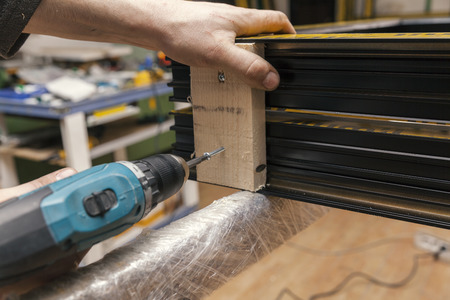 hand that screw into wood, close up