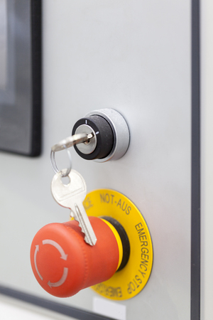 emergency stop red button with key on machine