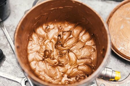 gold paint in bucket, close upの写真素材