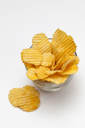 Ribbed potato chips with spices on white backgroundの写真素材