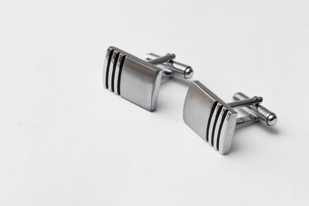 cufflinks silver on white backgrounds, close up
