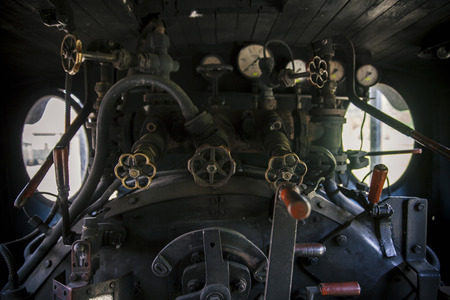 Controls of a vintage steam locomotive, boiler and gaugesの写真素材