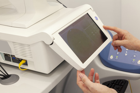 ophthalmologist with touch screen, close up