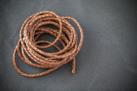 leather braids on black background, close upの写真素材