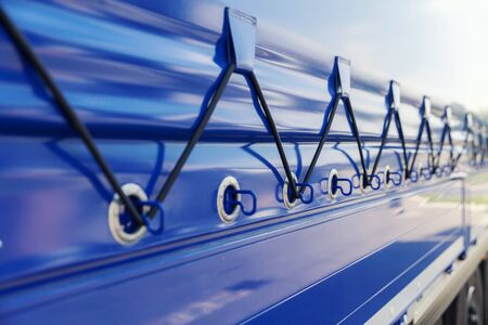 detail of blue tarp on the truck trailer, transportation backgroundの写真素材