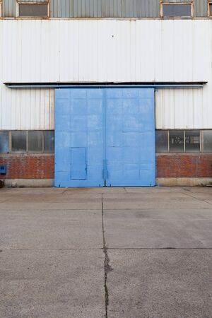 large industrial metal door from an abandoned factoryの写真素材