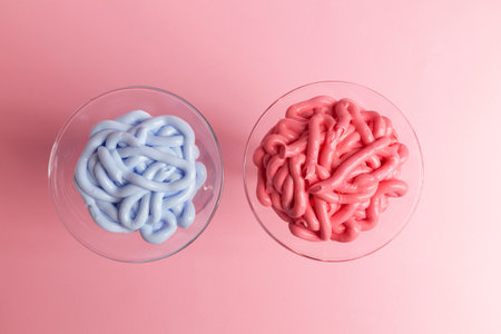 multicolored emulsions for cosmetic creams in glass on rose background, close upの写真素材