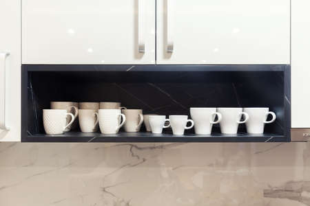 white coffee cups on a wooden shelf, copy spaceの写真素材