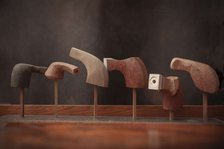 wooden pipes for smoking tobacco in the workshop, abstract background, close up, copy space
