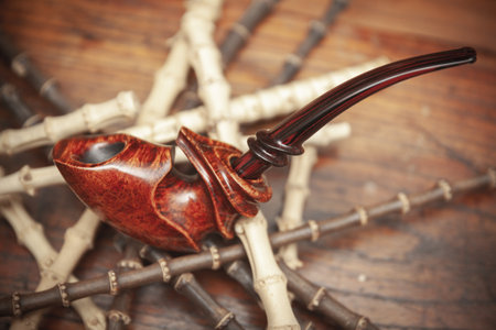 vintage smoking pipe on the leather background, close up