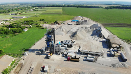 CHERKASSY REGION, UKRAINE - MAY 31, 2018: Aerial view on asphalt plant, the territory of the plant, the mountains of rubble, many kamazes, trucks., Road construction works. High quality photoのeditorial素材