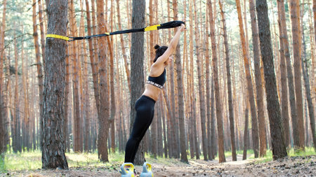 Beautiful, athletic, sexy young woman, coach, instructor, performs exercises, doing exercises. In...
