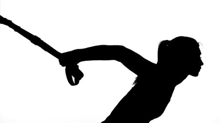 on a white background, a shadow, a black outline of a female figure doing exercises. High quality photoの写真素材