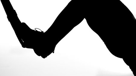 on a white background, a shadow, a black outline of a female figure doing exercises for the press. High quality photoの写真素材