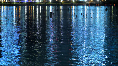 DUBAI, UNITED ARAB EMIRATES, UAE - NOVEMBER 20, 2017: Night Dancing fountain does not work, it is off, night view, close-up, in the water reflect skyscrapers. High quality photoのeditorial素材
