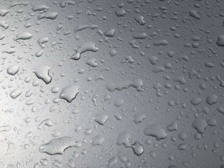 Detail of water drops on a gray car windowの素材