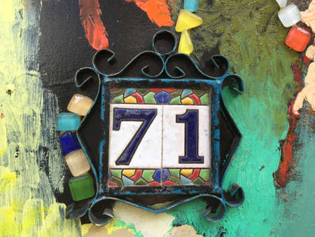 Vintage grunge square metal rusty plate of number of street address with number closeupの素材