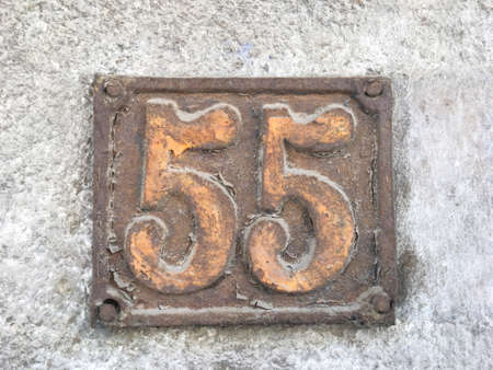 Vintage grunge square metal rusty plate of number of street address with number closeupの素材