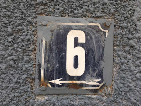 Vintage grunge square metal rusty plate of number of street address with number closeupの素材