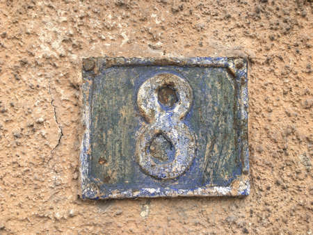 Vintage grunge square metal rusty plate of number of street address with number closeupの素材