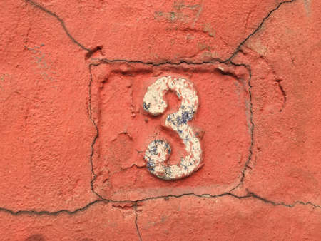 Vintage grunge square metal rusty plate of number of street address with number closeupの素材