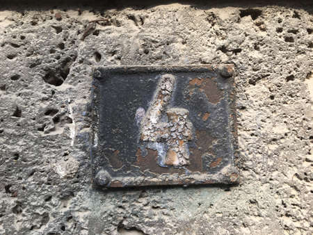 Vintage grunge square metal rusty plate of number of street address with number closeupの素材