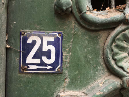Vintage grunge square metal rusty plate of number of street address with number closeupの素材