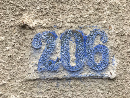 Vintage grunge square metal rusty plate of number of street address with number closeupの素材