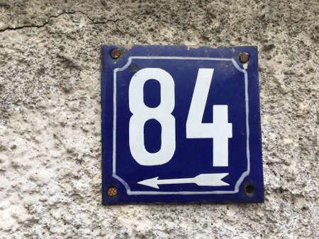 Vintage grunge square metal rusty plate of number of street address with number closeupの素材