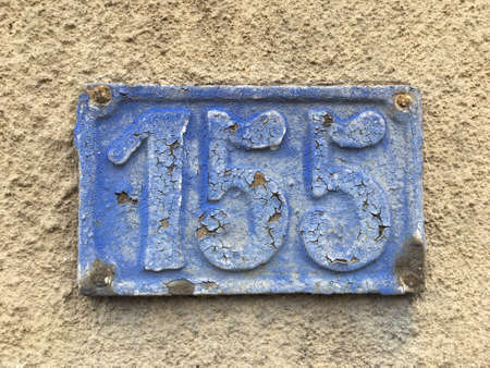 Vintage grunge square metal rusty plate of number of street address with number closeupの素材