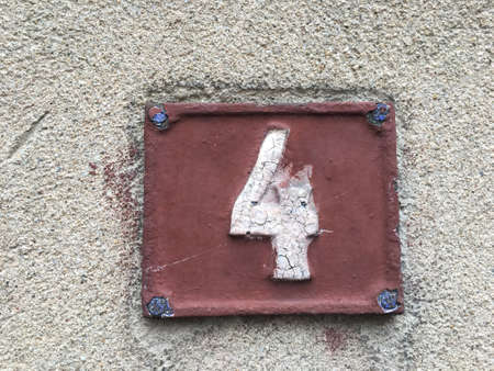 Vintage grunge square metal rusty plate of number of street address with number closeupの素材