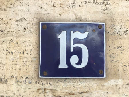Vintage grunge square metal rusty plate of number of street address with number closeupの素材