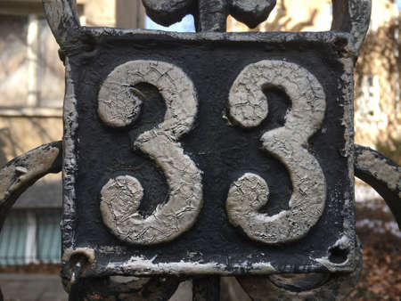 Vintage grunge square metal rusty plate of number of street addressの素材