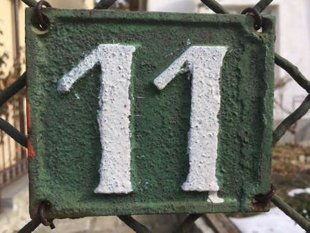 Vintage grunge square metal rusty plate of number of street addressの素材