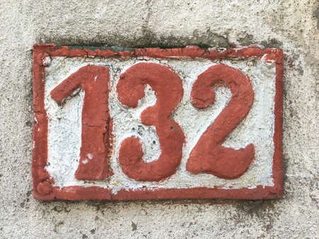 Vintage grunge square metal rusty plate of number of street addressの素材