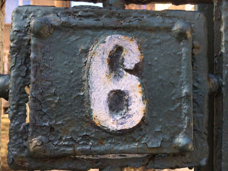 Vintage grunge square metal rusty plate of number of street addressの素材