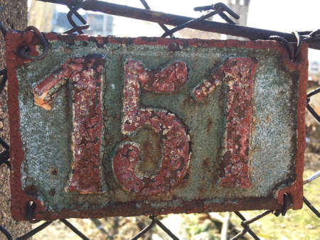Vintage grunge square metal rusty plate of number of street address